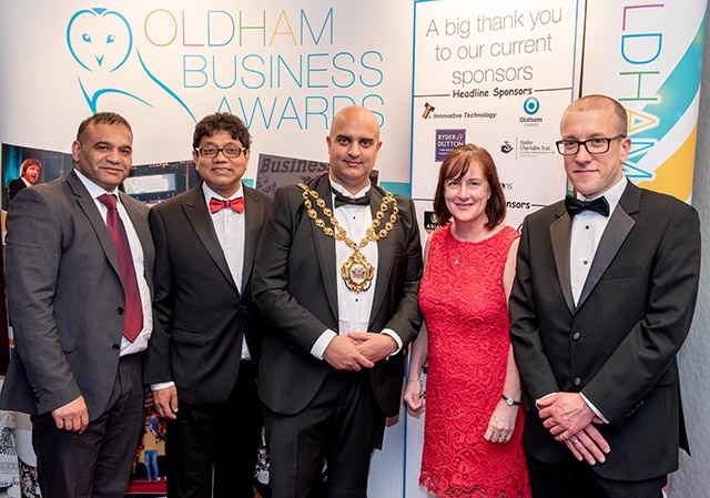 The Mayor of Oldham, Councillor Shadab Qumer (centre), with fellow dignitaries at the QE Hall
