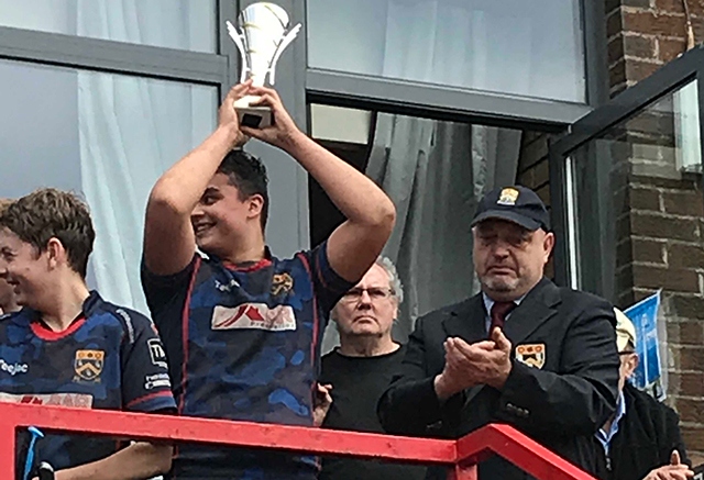 Oldham captain Max Walsh shows off the silverware