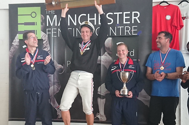 Chris Heaps celebrates his gold medal-winning effort in the over-40s mens' epee event