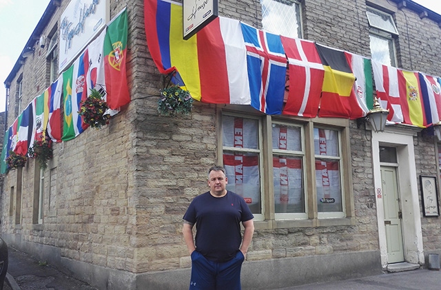Mark Howard outside his flag-draped Top House pub in Lees