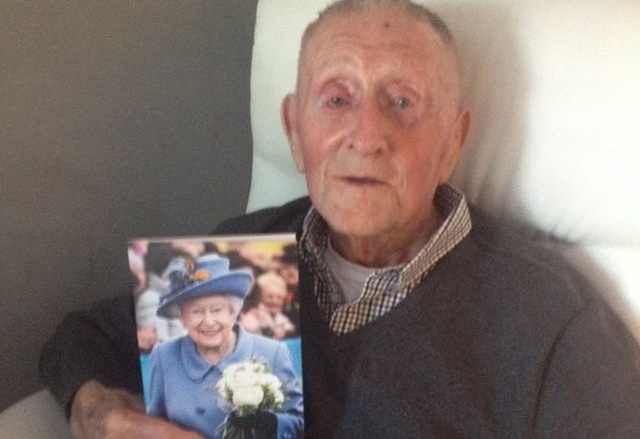 John Dodd is pictured with his telegram from the Queen