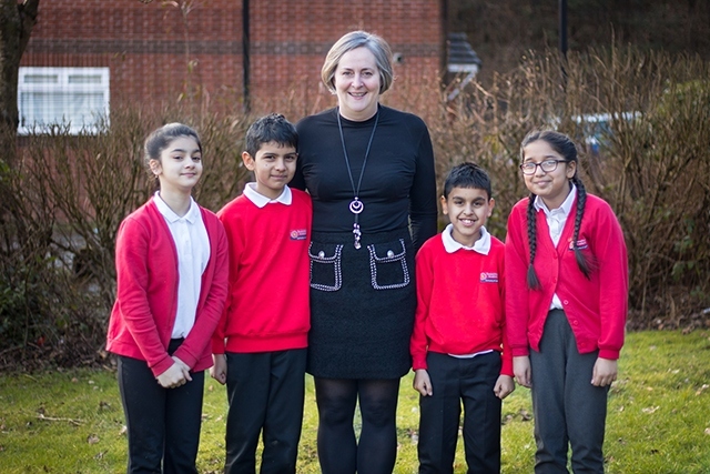 Roundthorn Primary School Executive Principal Lisa Needham with some of her happy pupils