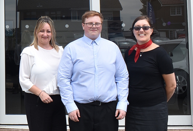 Bradley Taylor alongside his managers at RRG Peugeot Oldham