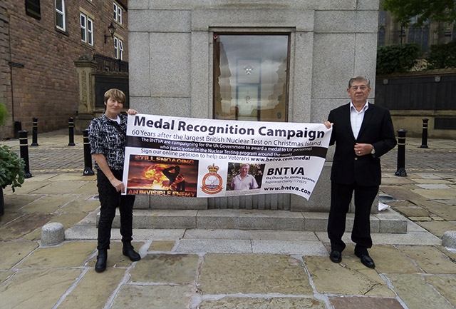 Veteran Terry Quinlan pictured at the Oldham war memorial with his daughter Ann