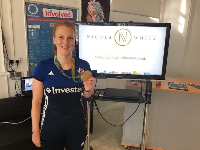 Nicola White shows off her Olympic Gold medal at Oldham College