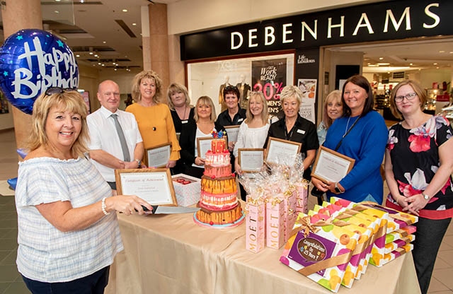 Centre Manager Mike Flanagan is pictured with members of the Debenhams team who have worked in the store since it opened in 1993