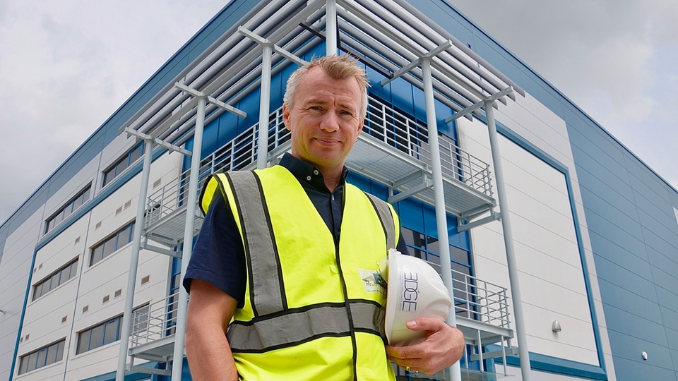 Adam Sedgwick of Edge Structural Design at Haydock Green in front of balcony steelwork at the warehouse reception.