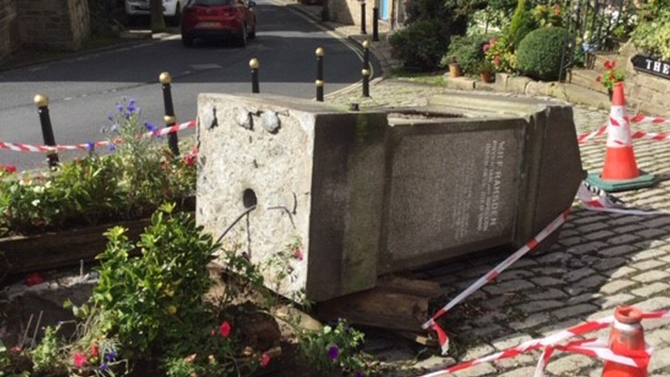 The damaged memorial in dobcross square 