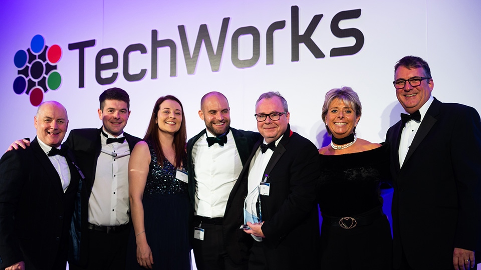 Mick Conlon (holding trophy) and colleagues receive the 2019 TechWorks Manufacturing Site of the Year Award for Diodes Incorporated (Oldham) - alongside compere Penny Power OBE and Techworks CEO, Alan Banks (right) and John Summers and Dominic Flynn of sponsor Logos Logistics