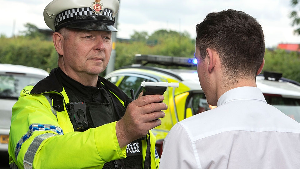 GMP officer carrying out a breath test