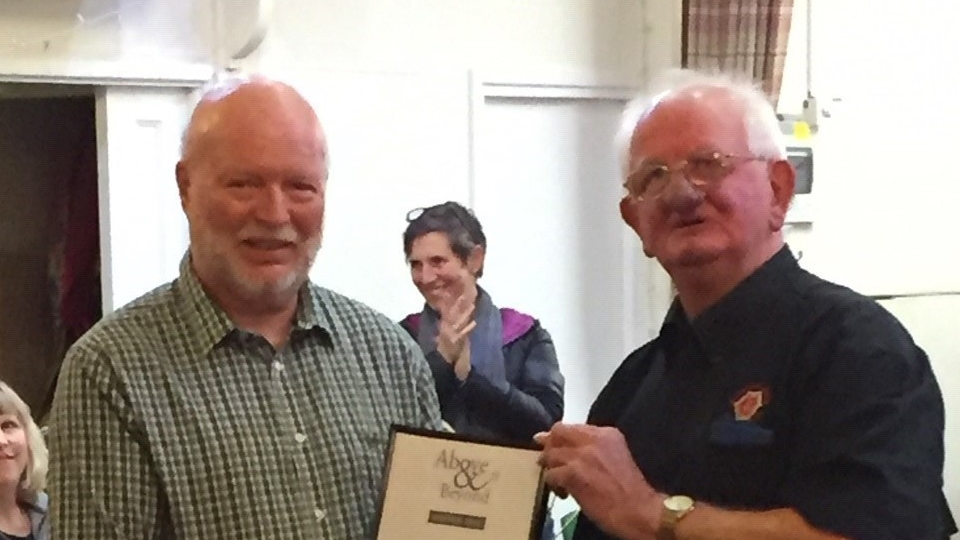 Phil Cumberworth, left receives his award from John Holden 

