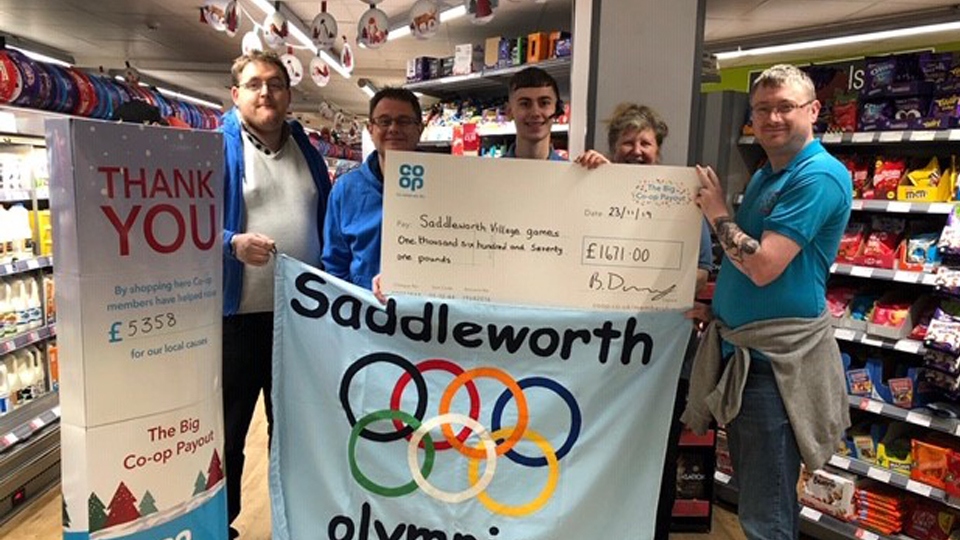 Pictured receiving their cheques from Coop store staff members, Louie Daley, Sophie Ball, Wendy Johnson and Martin Poole are Adrian Green, Stephen Hewitt and Scott Longley from the Saddleworth Village Olympics.