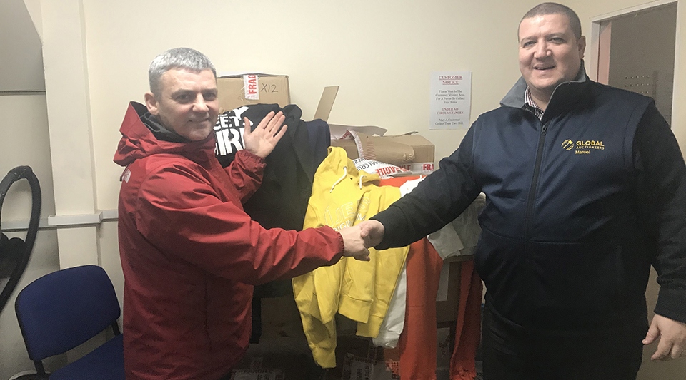 Marcel Duffy (right) hands over the tops and track suits