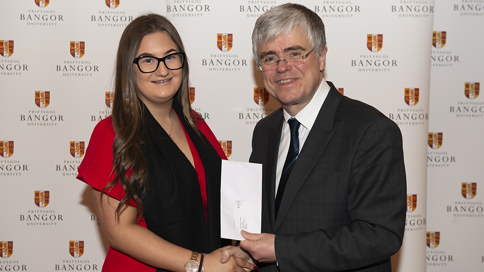 Liberty Kwai Wilcox is pictured receiving an award from Professor Iwan Davies, Vice-Chancellor of Bangor University Liberty Kwai Wilcox is pictured receiving an award from Professor Iwan Davies, Vice-Chancellor of Bangor University