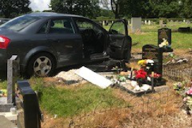 The car crashed into several gravestones before two people inside fled the scene