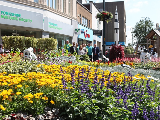 Cllr Ur-Rehman, Carol Brown (Director of Environmental Services), staff from the Environmental Services team and Glenn Dale (Head of Environmental Services) are pictured at the Oldham Bloom and Grow WOW Bed