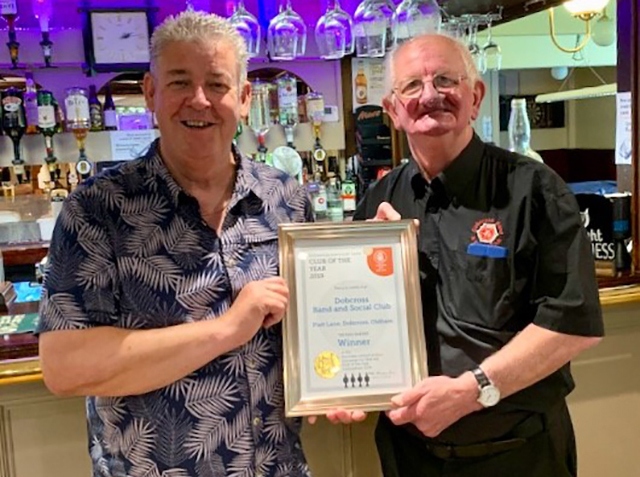 Just champion: CAMRA chairman Peter Alexander (left) presents Dobcross Band Club  steward John Holden with the award. Picture courtesy of Michelle Riley. 
