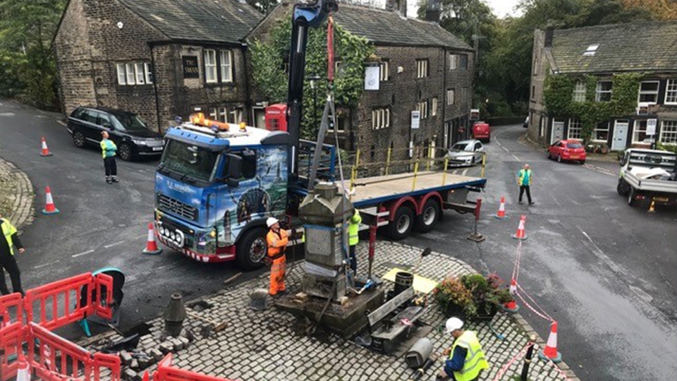 Teams work to restore the historic monument in Dobcross