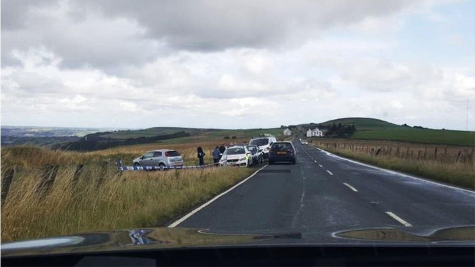 Police at the scene of the abandoned car