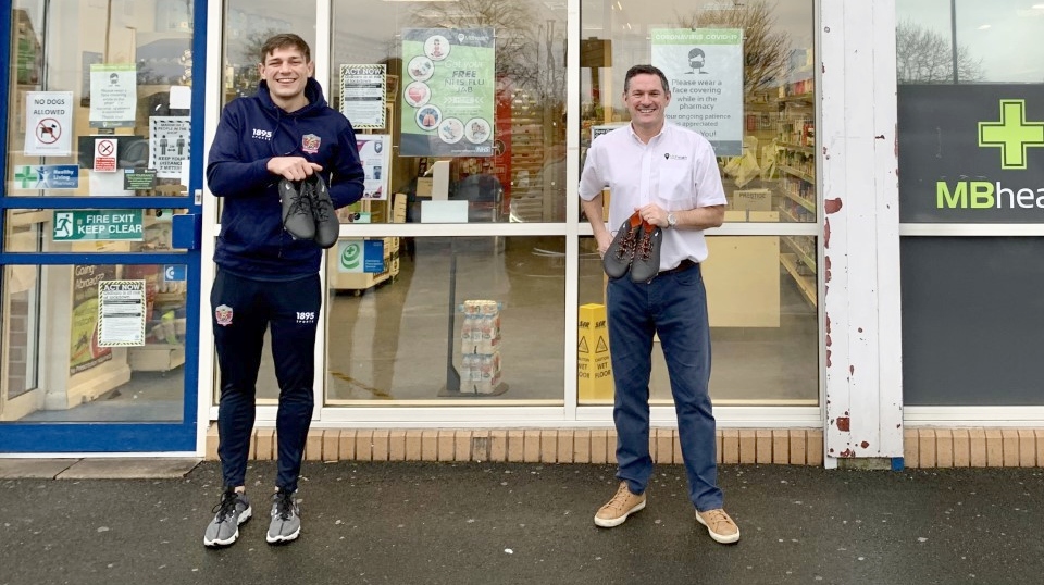 Picture show Bent (left) and Martin Molyneux, of St Chad's pharmacy, showing off the boots outside the Lime Green Parade store.