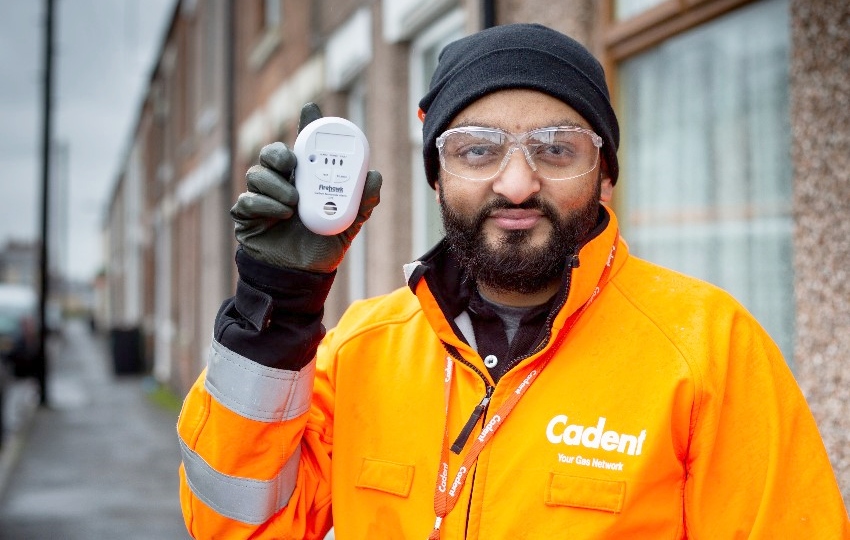 Cadent engineer Mo Dawood holding a carbon monoxide alarm