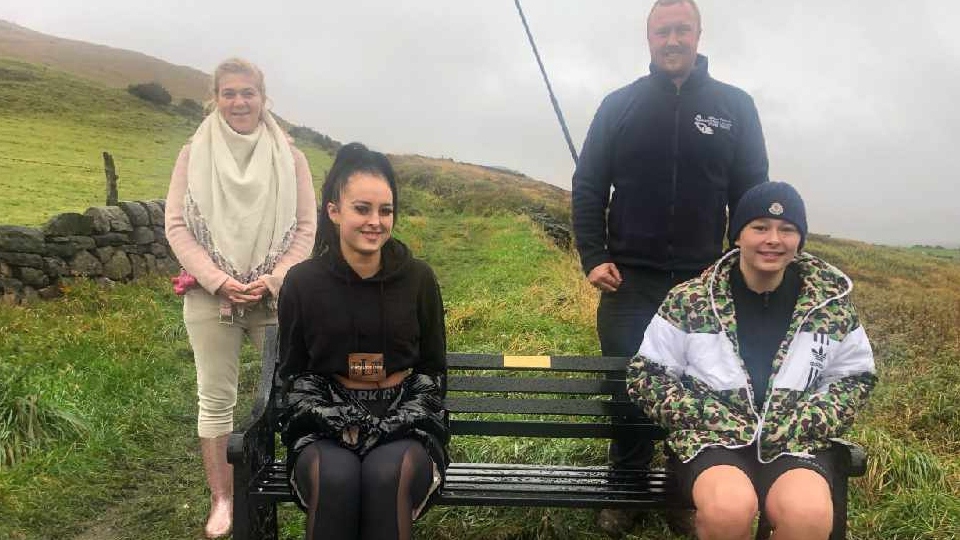 Three of PC Warburton's grandchildren, Ashleigh Holroyd, Joe Sothcott and Sam Gill, are pictured with Dovestones WI president Jessica Moreland