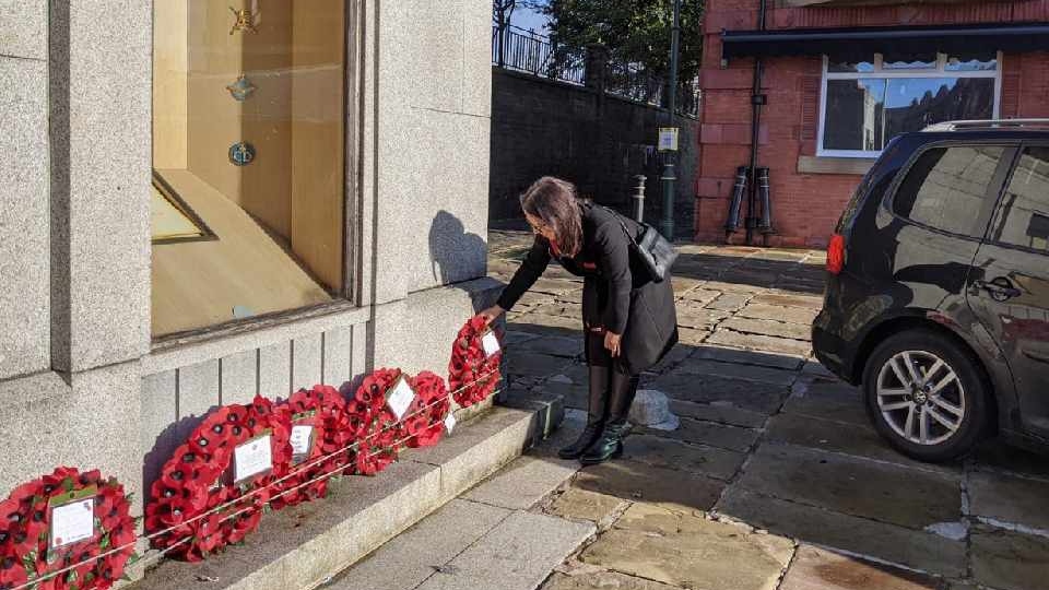 MP Debbie Abrahams pictured laying a wreath at the town centre memorial
