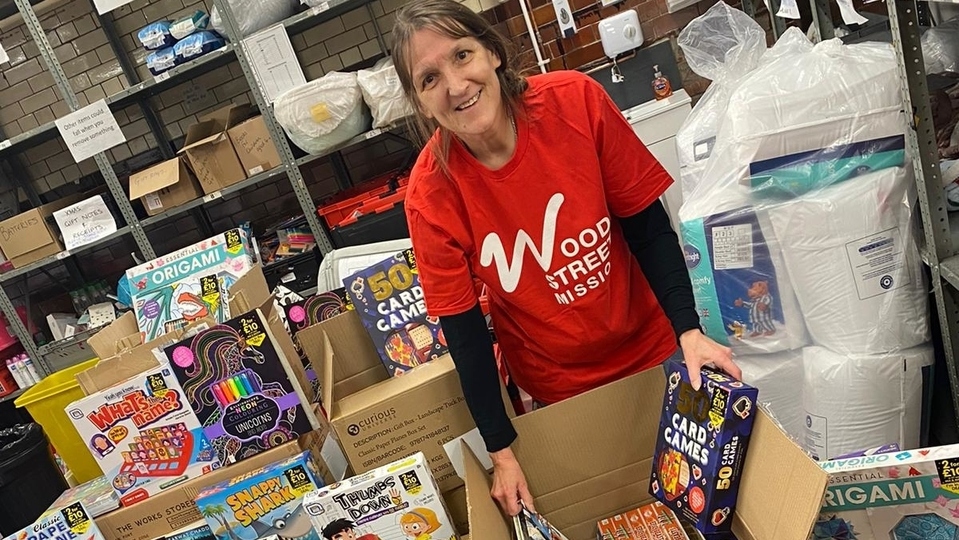 A Wood Street Mission volunteer is pictured with some of the Swansway donations