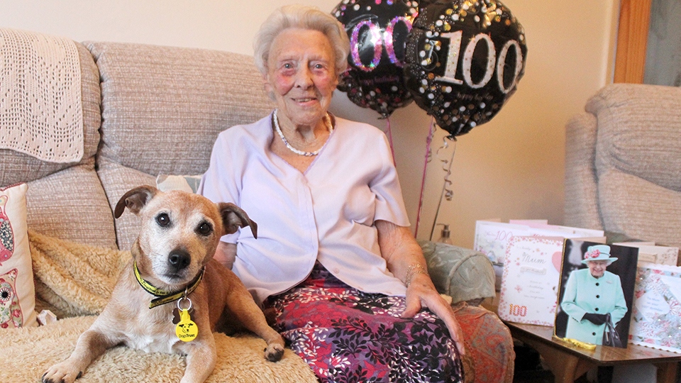 Marjorie with Paddy and her card from the Queen 