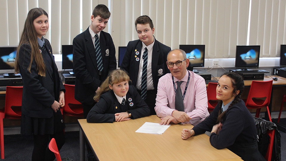 Saddleworth school executive headmaster Matthew Milburn with some of his senior students.