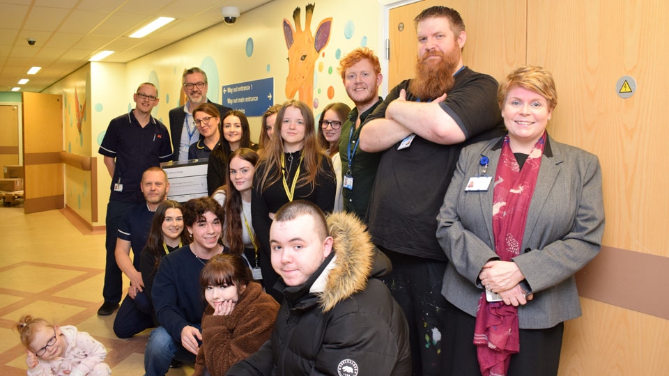 Pictured (R-L): Royal Oldham Chief Officer and Director of Nursing, Nicola Firth with Oldham College Principal Alun Francis and Fine Art students from Oldham College