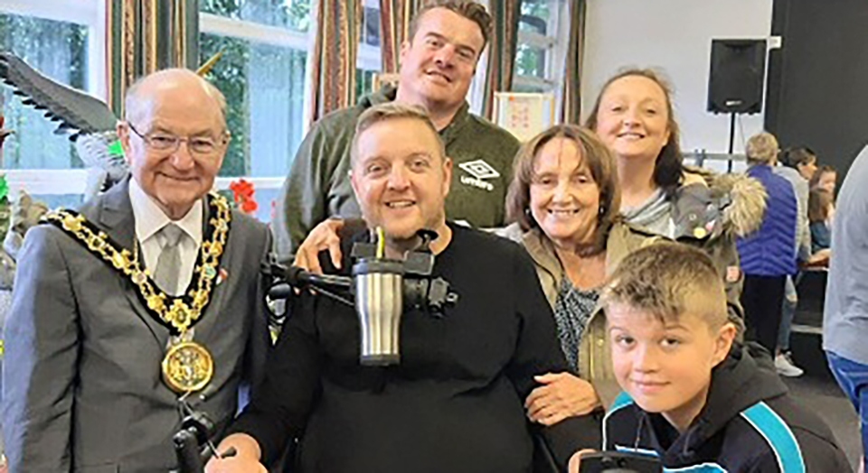 Andy Walker MBE pictured (centre) at a Rochdale Council function last year