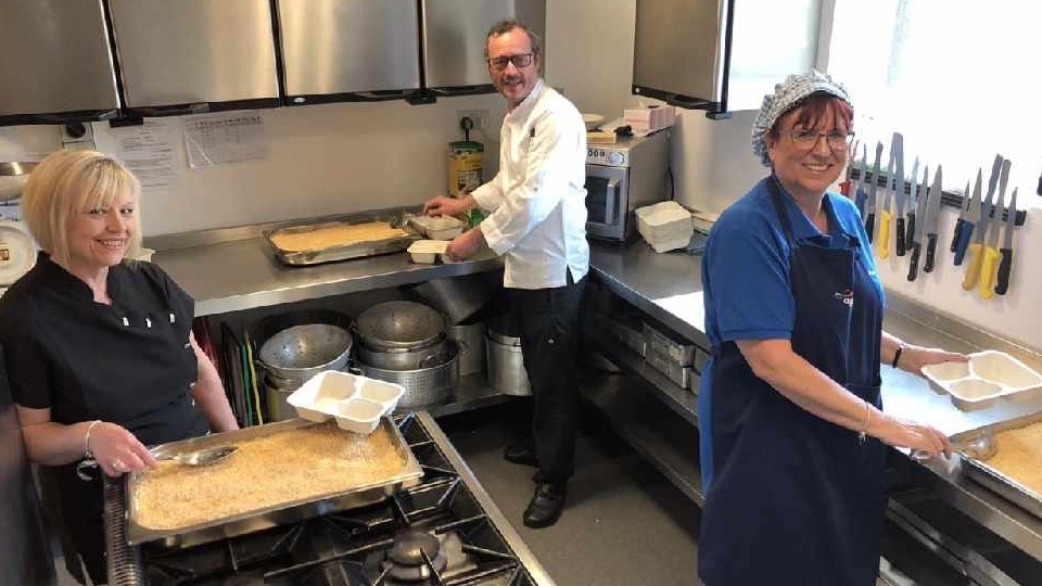 Pictured, from the left: Julie Hey, Head Chef at Age UK, Mike Shaw, Chef from the White Hart and Yvonne Green, Age UK Supervisor portioning up the fish pie in the Link Centre kitchen