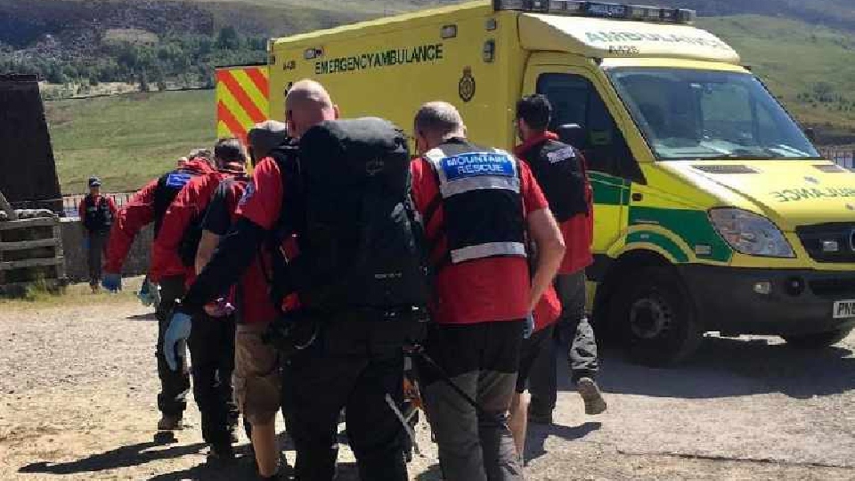 The casualty is helped into a waiting ambulance