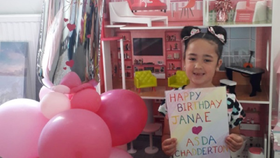 Seven-year-old Janae pictured with her doll's house