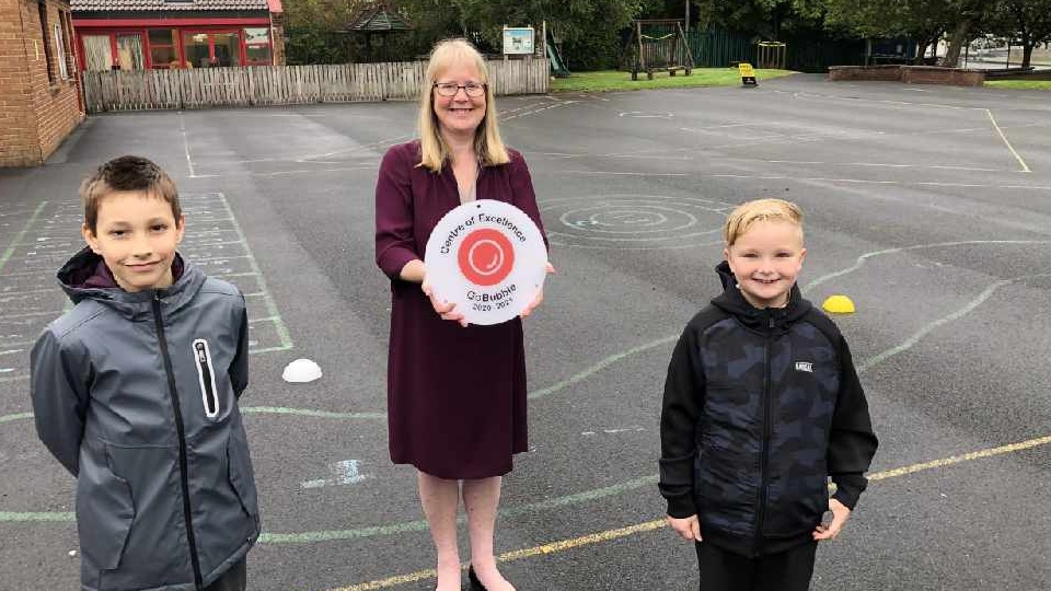 Mrs Milligan proudly shows off St Herberts' award Mrs Milligan proudly shows off St Herberts' award