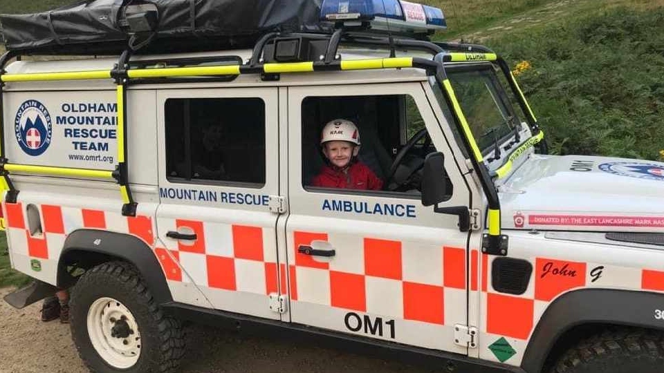 Youngster Henry is pictured in an Oldham Mountain Rescue Team vehicle