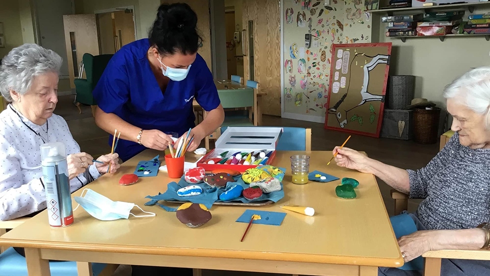 Stones wood team member works with the homes residents 