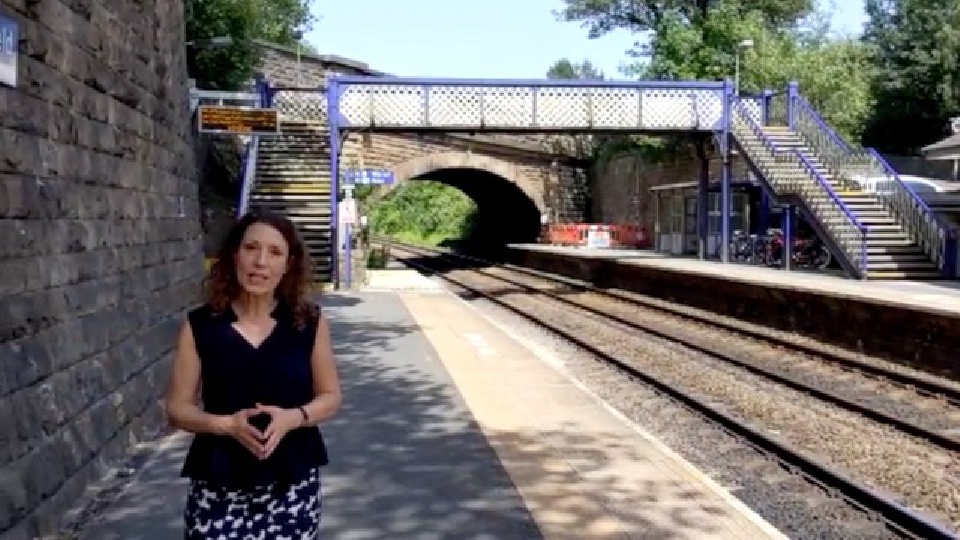 MP Debbie Abrahams is pictured at Greenfield station in front of the footbridge which is inaccessible for many disabled residents, people with prams or anyone who is unable to use stairs