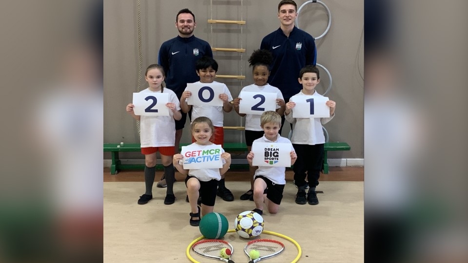 Jack Kendall (Operations Manager, back left) and Lewis Bradley (Primary PE Specialist) with students from a Dream Big Sports group Jack Kendall (Operations Manager, back left) and Lewis Bradley (Primary PE Specialist) with students from a Dream Big Sports group