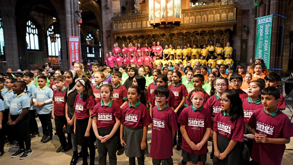 Children from Broadfield Primary School (in yellow) take part in Manchester Sings