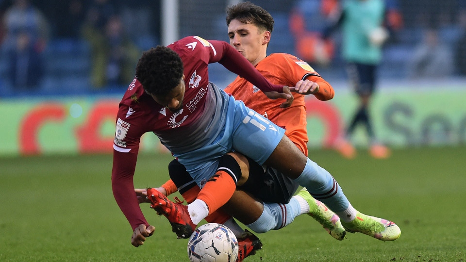 Oldham Athletic's Callum Whelan with Myles Hippolyte of Scunthorpe United