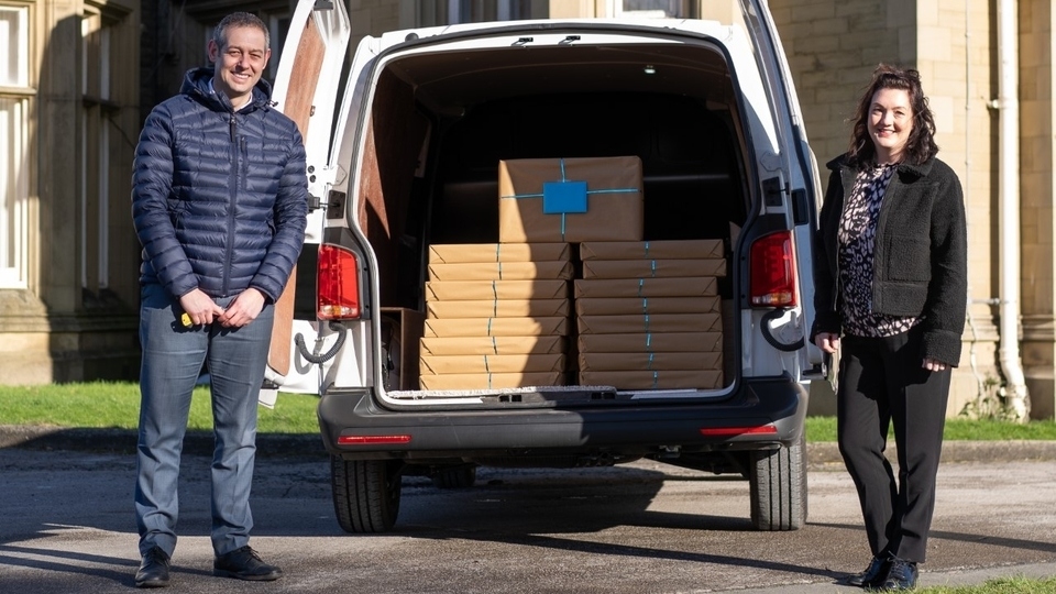 Gary Wood (business manager, Oldham Volkswagen) with Carla Dickinson from Homestart collecting the laptops 