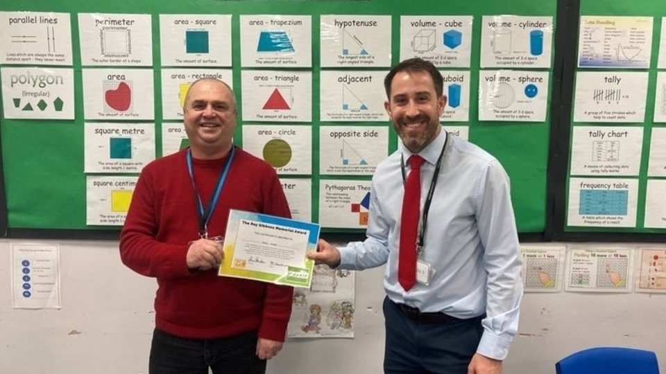 Vasile is pictured (left) being presented with his award Vasile is pictured (left) being presented with his award