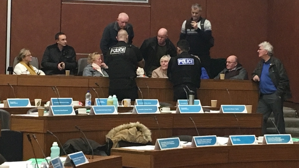 Police were called to talk to protesters at a meeting of Oldham full council