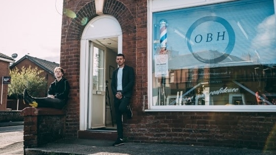 Barber and business owner Darren O'Neill (right) and Jack are pictured outside their Failsworth premises