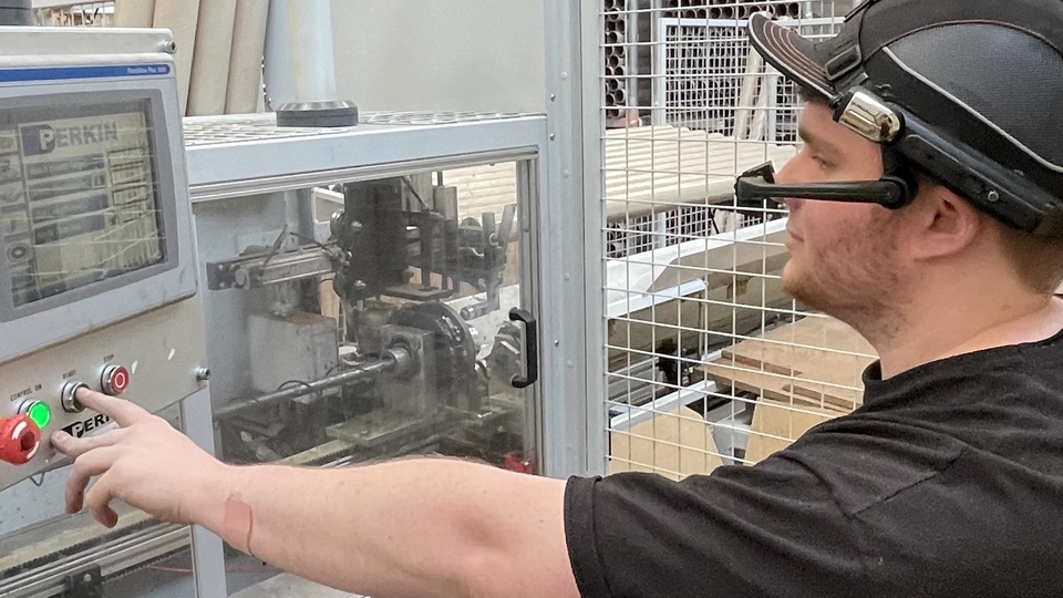 A machine operator testing out handsfree smart glasses. A machine operator testing out handsfree smart glasses.