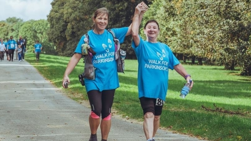 Parkinson's fundraisers taking part in a walk. Parkinson's fundraisers taking part in a walk.