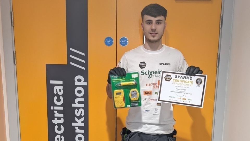 Adam Pitcher with his Certificate of Achievement and prizes from the Spark Grand Final