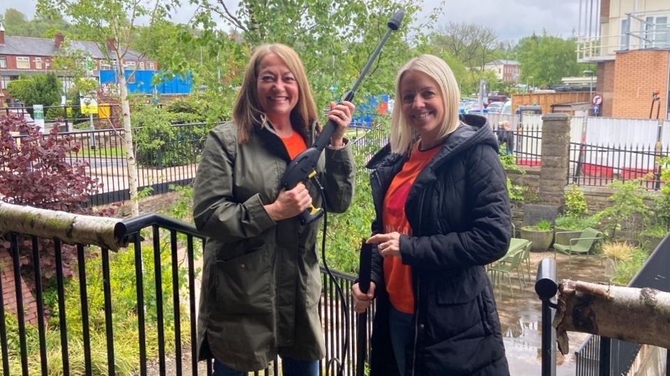 Pearson volunteers Suzanne and Dawn get stuck into the jet-washing at Maggie's